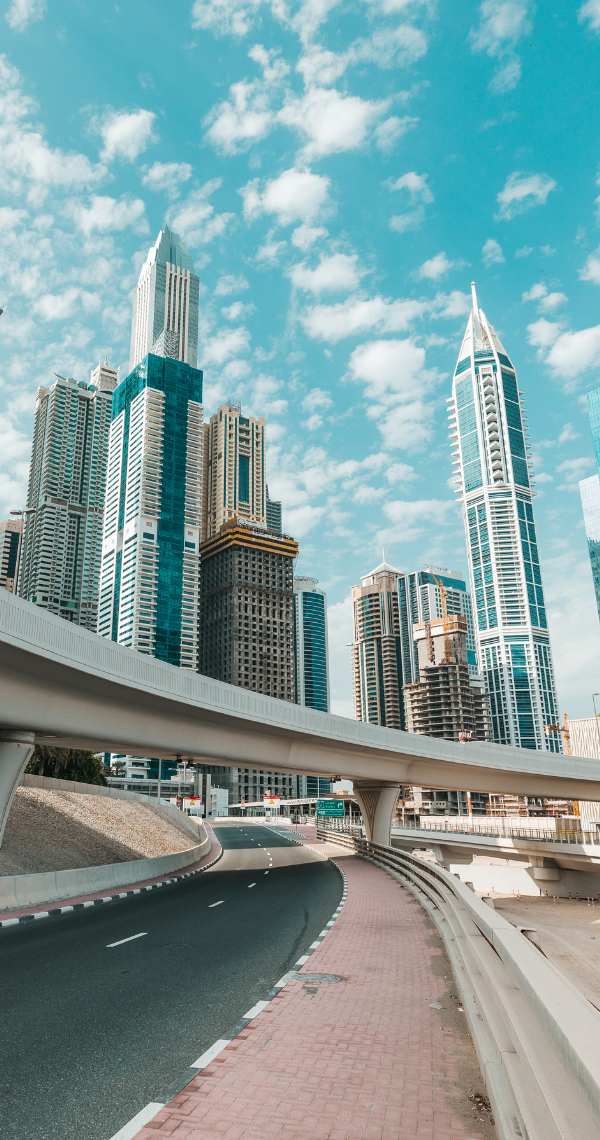 Elevated highway flyover curving past high-rise towers